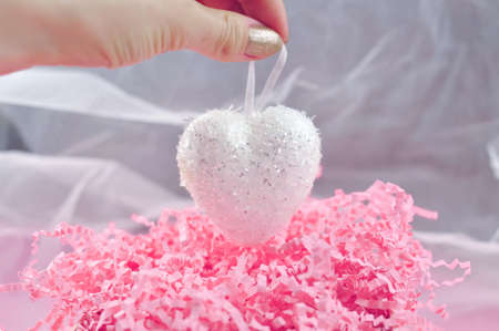 White heart on pink background love conceptの写真素材