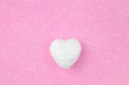 White heart on pink background love conceptの写真素材