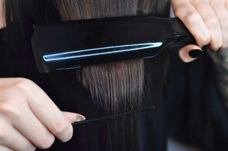 Combing hair with hairbrush macro view copy space . High quality photoの写真素材