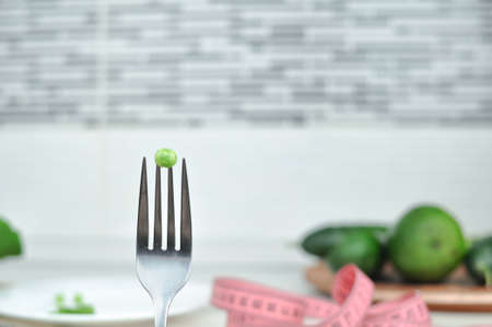 Pink tape measure and green vegetables diet concept . High quality photo