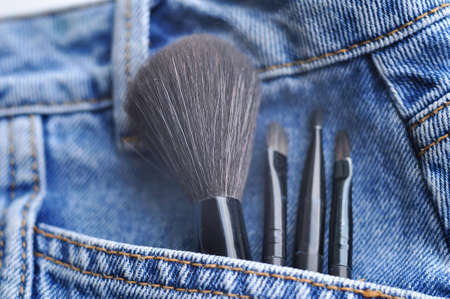Brushes for woman's face ad make up on jeans background . High quality photoの写真素材