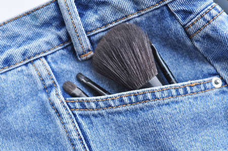 Brushes for woman's face ad make up on jeans background . High quality photoの写真素材