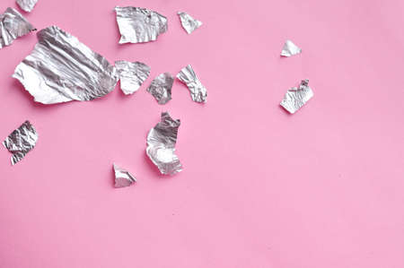 Sheets of steel foil on pink background copy space. High quality photoの写真素材