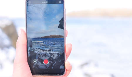 Smartphone in the hand winter mobile shooting . High quality photoの写真素材