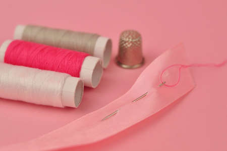 Equipment for sewing on pink background copy space. High quality photoの写真素材