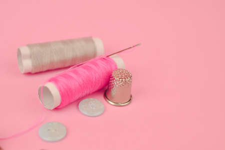 Equipment for sewing on pink background copy space. High quality photoの写真素材