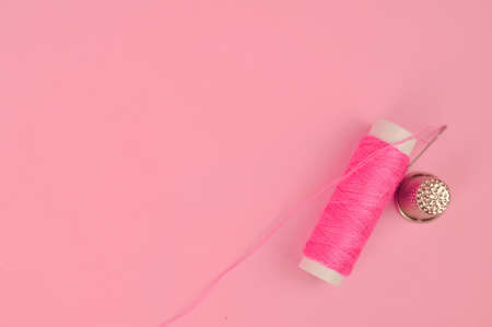 Equipment for sewing on pink background copy space. High quality photoの写真素材