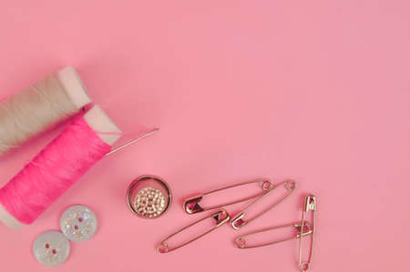Equipment for sewing on pink background copy space. High quality photoの写真素材