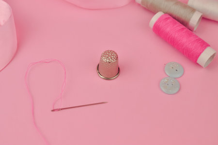 Equipment for sewing on pink background copy space. High quality photoの写真素材