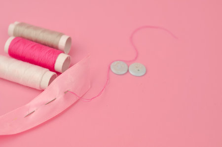Equipment for sewing on pink background copy space. High quality photoの写真素材
