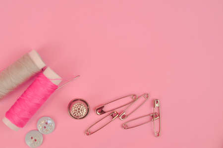 Equipment for sewing on pink background copy space. High quality photoの写真素材