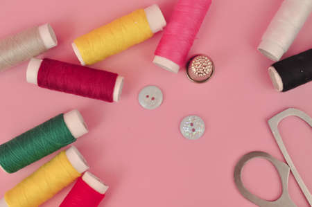 Equipment for sewing on pink background copy space. High quality photoの写真素材
