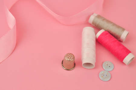 Equipment for sewing on pink background copy space. High quality photoの写真素材
