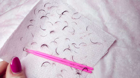 Removed fake lashes for lash extensions on pink napkin. High quality photoの写真素材