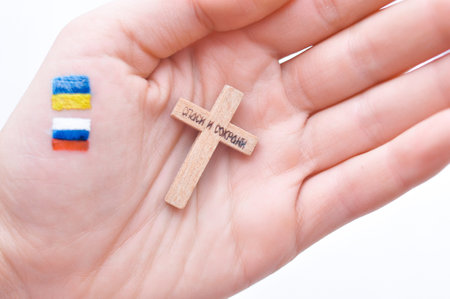 Orthodox Christ and drawned Russian and Ukrainian flags in hand. High quality photo.war and piece...