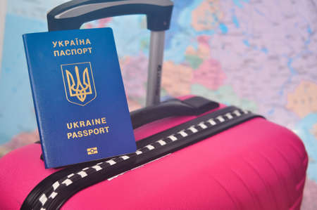 Ukrainian international passport and world map refugee concept . High quality photoの写真素材