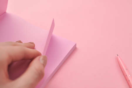 Making notes in pink notebook copy space . High quality photo