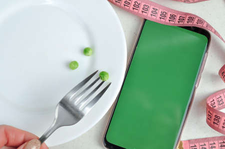Smartphone with green screen and fresh vegetables copy space. High quality photoの写真素材