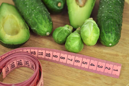 Pink tape measure and green vegetables diet concept . High quality photoの写真素材