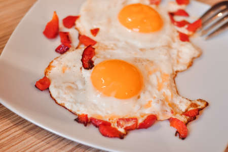 Two Fried eggs on pan with red pepper morning breakfast . High quality photoの写真素材