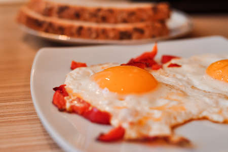 Two Fried eggs on pan with red pepper morning breakfast . High quality photoの写真素材