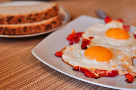 Two Fried eggs on pan with red pepper morning breakfast . High quality photoの写真素材