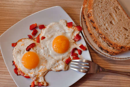 Two Fried eggs on pan with red pepper morning breakfast . High quality photoの写真素材