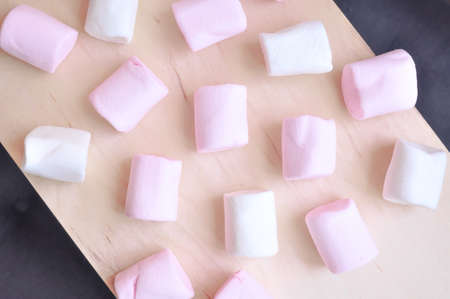 Close up of pink and white fluffy marshmallows sweet candy for tea and coffee breakの写真素材