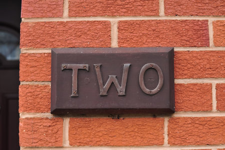 The word two on the red brick wall backgroundの写真素材