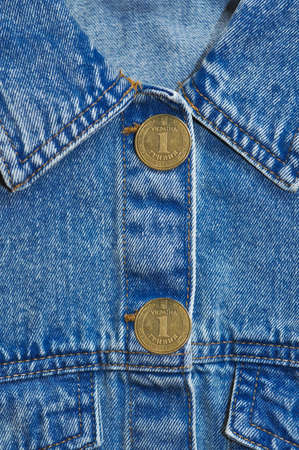 Part of Jeans jacket with gold coin cuffings and buttons .denomination one hryvnia.translation from Ukrainian :Ukraine, 1 hryvnia.の写真素材