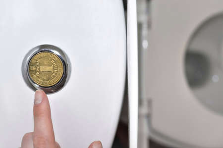 faucets in the bathroom with a Ukrainian hryvnia coin, translation from Ukrainian: one hryvnia, ukraine. utility bills concept.の写真素材