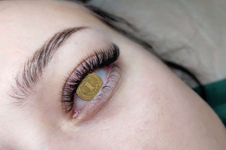 Price of lash extension in Ukraine concept. Translation from Ukrainian :one hryvnia, Ukraine . High quality photoの写真素材