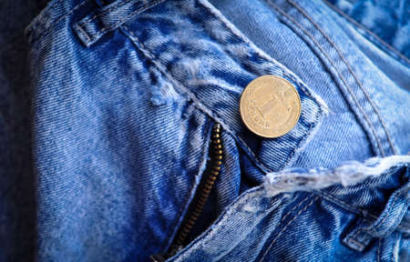 Part of Jeans jacket with gold coin cuffings and buttons .denomination one hryvnia.translation from Ukrainian :Ukraine, 1 hryvnia.の写真素材