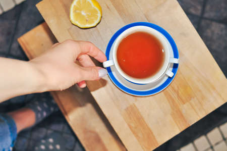 close up of cup of black tea with blue stripes at home ,teatime and relaxの写真素材