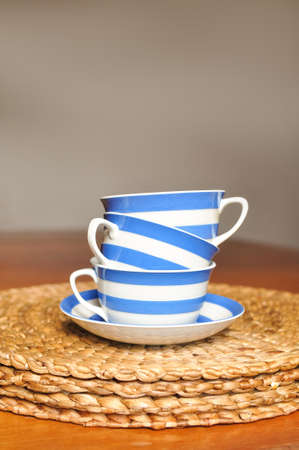 close up of cup of black tea with blue stripes at home ,teatime and relaxの写真素材