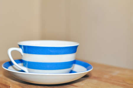 close up of cup of black tea with blue stripes at home ,teatime and relaxの写真素材