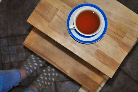 close up of cup of black tea with blue stripes at home ,teatime and relaxの写真素材
