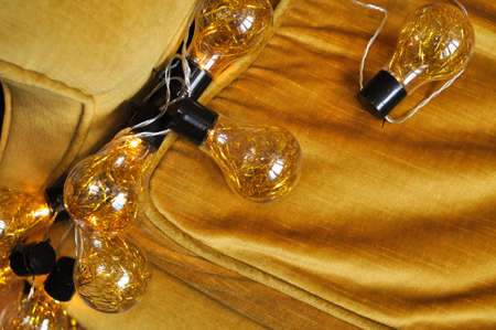 sparkling gold christmas garland with lights on the arm chair,decoration for holidays