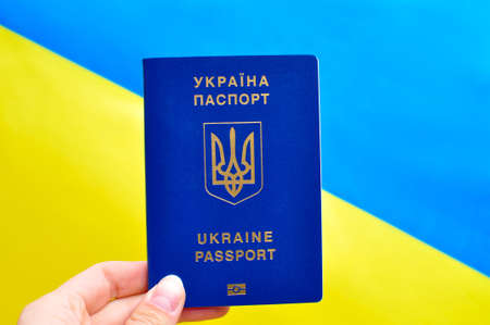 Ukrainian internUkrainian international biometric passport and bag for travel close up.Translation from Ukrainian: 'Ukraine, passport'.の写真素材
