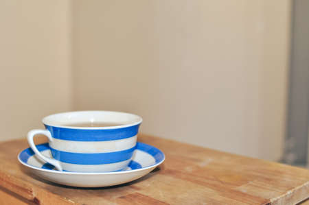 close up of cup of black tea with blue stripes at home ,teatime and relaxの写真素材