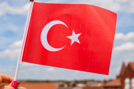 the national red flag of Turkey in hand close up,moon and star.の写真素材