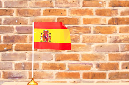 close up of National Spanish flag yellow and red colors,hand holding flag.の写真素材