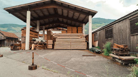 Big storage of wooden bricks in the village in mountains. High quality photoの写真素材