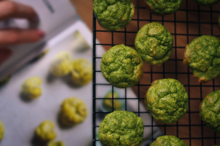 ready-made small green muffins with spinach on a baking sheet.healthy eating conceptの写真素材