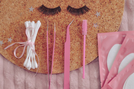 Equipment for eyelash extensions in beauty salon, glue, pink tweezers, strip lashes, flatlay . High quality photoの写真素材
