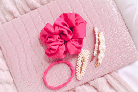 Set of pearl hairpins and elastic bands on pink background . High quality photoの写真素材