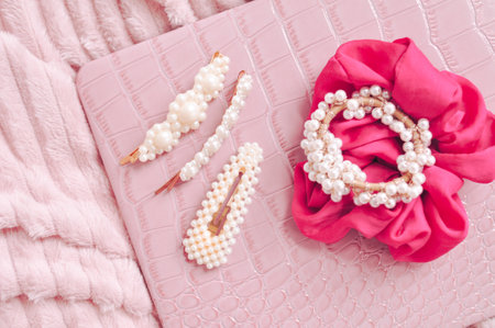 Set of pearl hairpins and elastic bands on pink background . High quality photoの写真素材