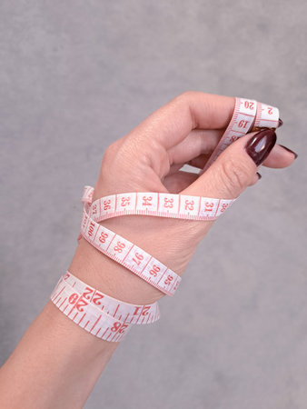 Close up of measure tape in hand copy space. High quality photo