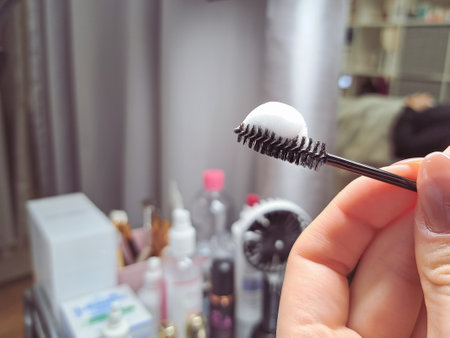 Black brush for eyelashes with lash shampoo foam ,cleaning lashes concept. High quality photo