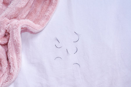 Bunches of fake lashes fell down after eyelash extensions, beauty salon problems. High quality photoの写真素材